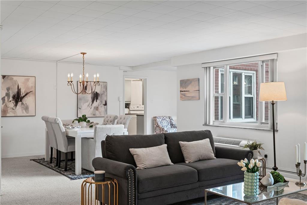 4601 Fifth Avenue, Unit 226 Pittsburgh, PA 15213 - Photo 4 of 34 a living room with furniture and a chandelier