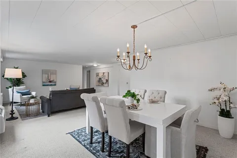 a view of a dining room with furniture and chandelier