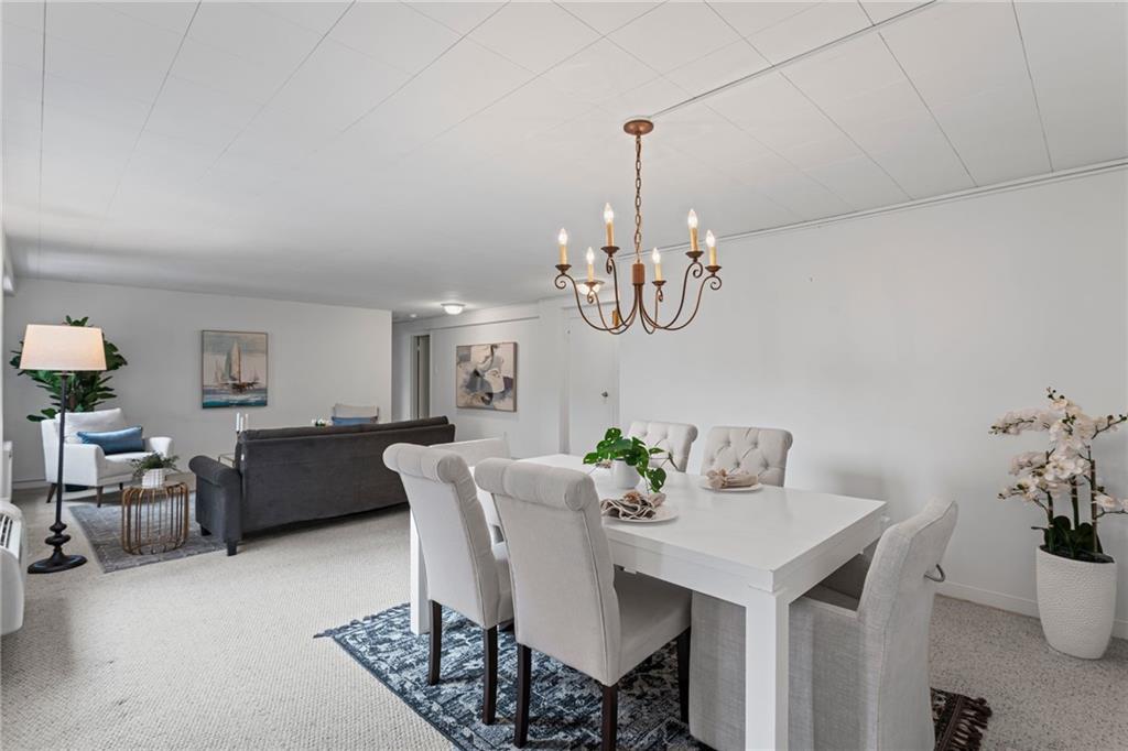 4601 Fifth Avenue, Unit 226 Pittsburgh, PA 15213 - Photo 5 of 34 a view of a dining room with furniture and chandelier