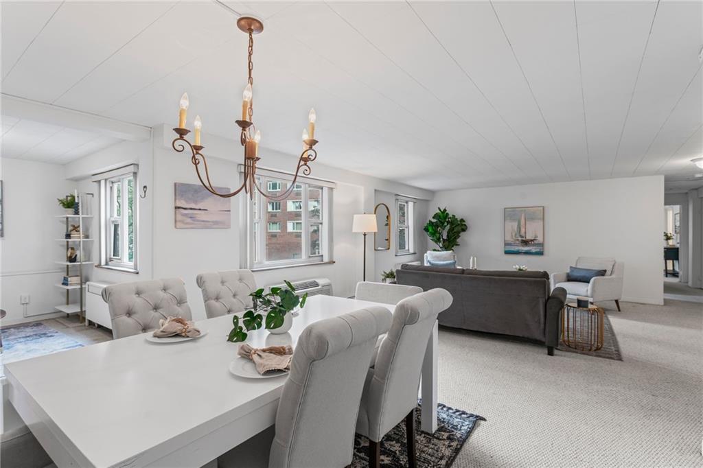 4601 Fifth Avenue, Unit 226 Pittsburgh, PA 15213 - Photo 6 of 34 a living room with furniture a chandelier and a dining table