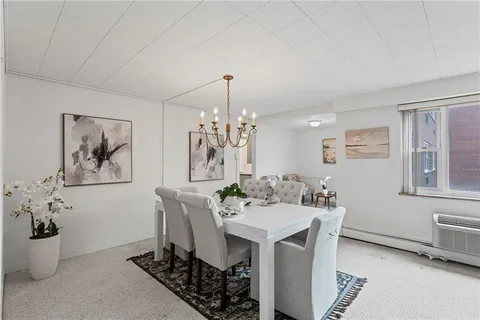 a view of a dining room with furniture and a chandelier