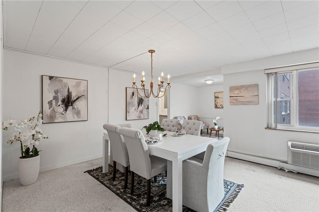 4601 Fifth Avenue, Unit 226 Pittsburgh, PA 15213 - Photo 7 of 34 a view of a dining room with furniture and a chandelier