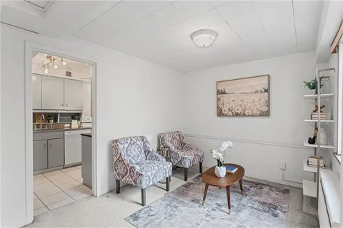 a living room with furniture and kitchen view