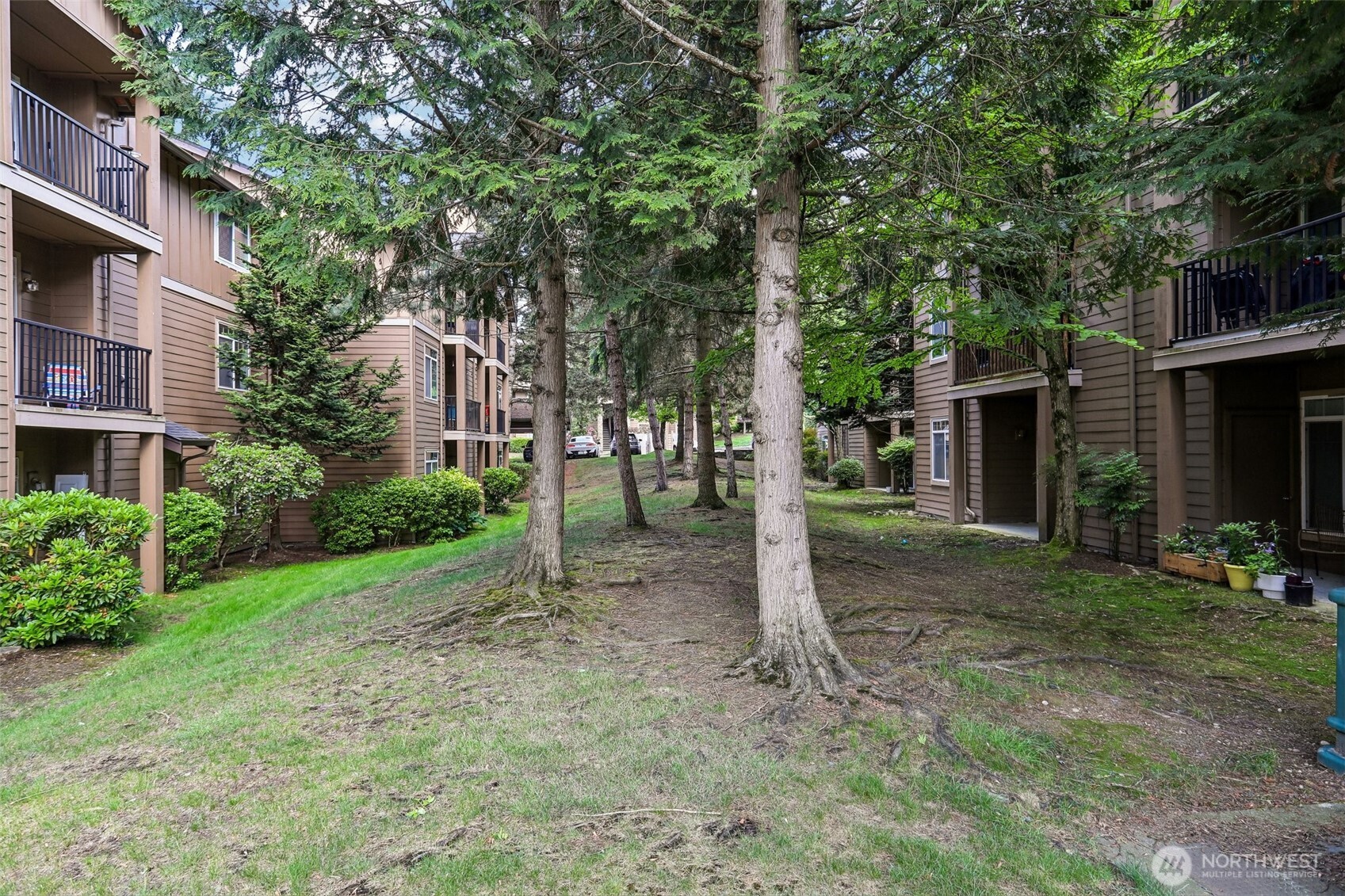 18930 Bothell Everett Highway, Unit E301 Bothell, WA 98012 - Photo 23 of 28 a view of a house with a yard