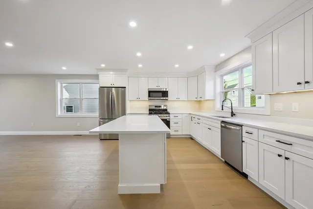 a kitchen with a sink window and cabinets