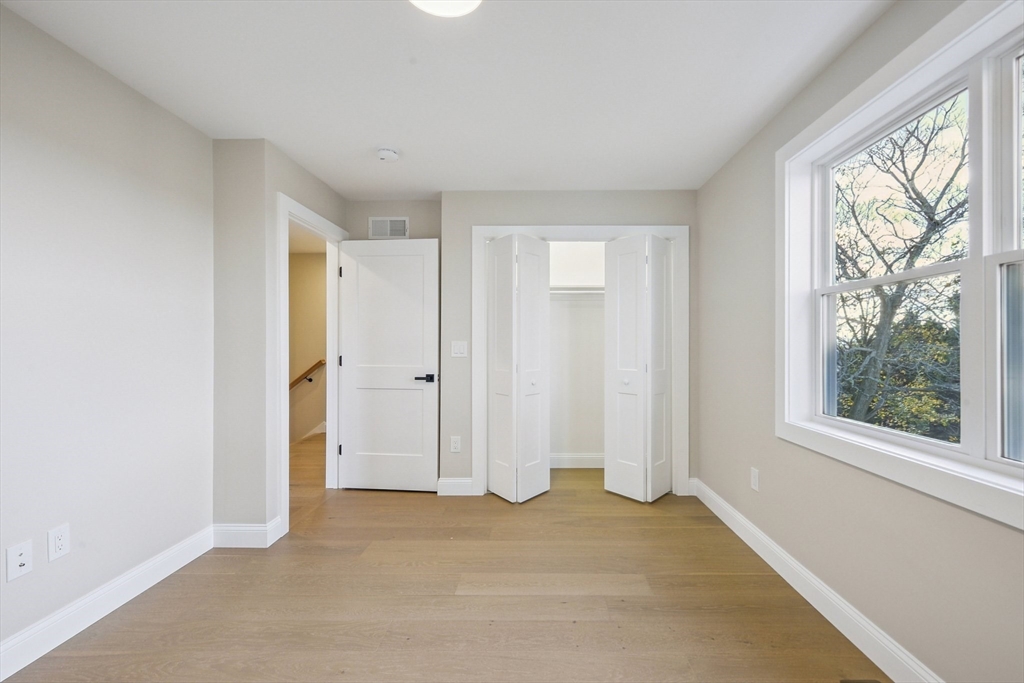122 Stowe Street, Unit 122 Fall River, MA 02720 - Photo 10 of 21 wooden floor in an empty room with a window