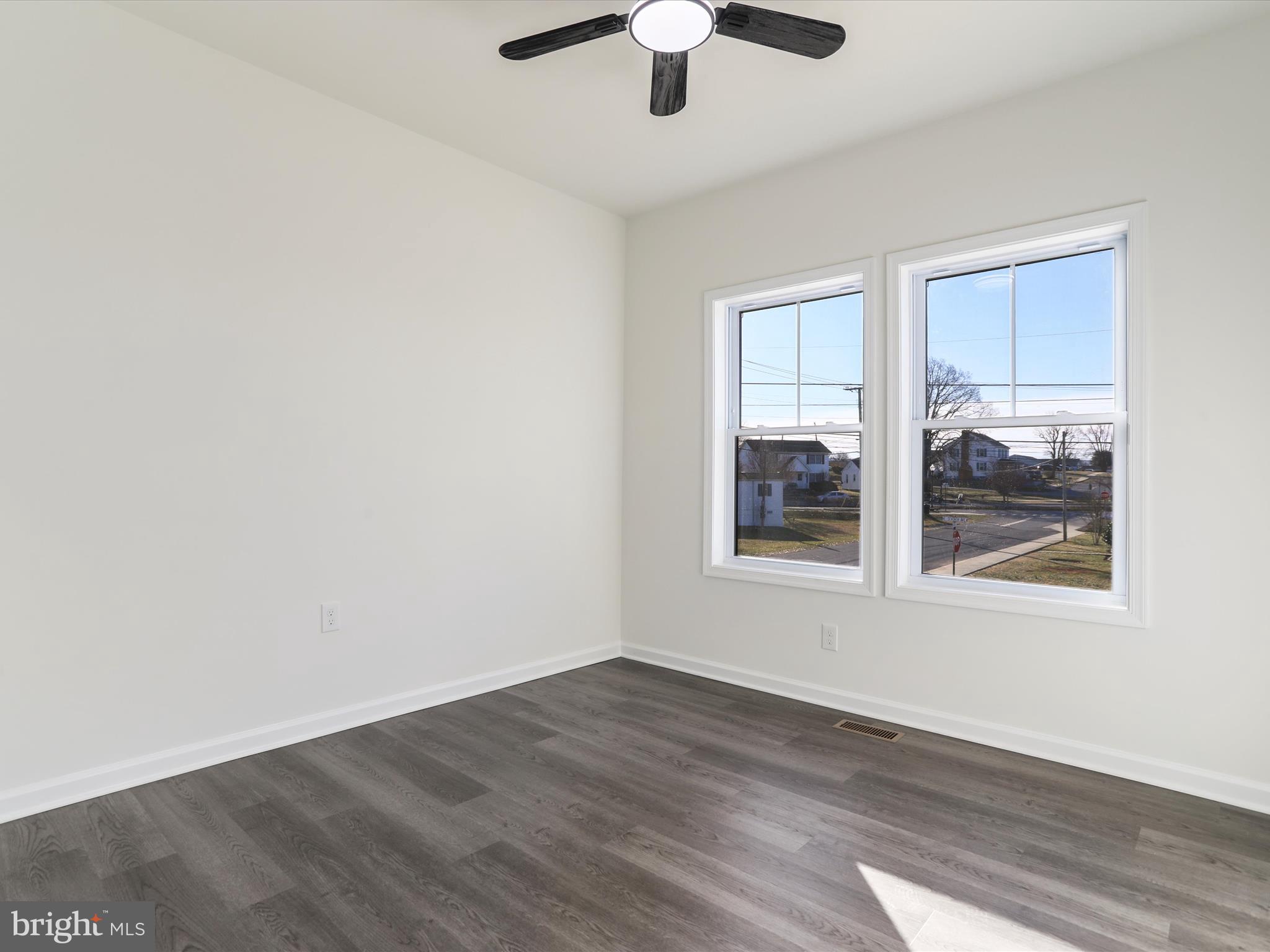 117 East 7th Avenue Ranson, WV 25438 - Photo 23 of 29 an empty room with wooden floor and windows