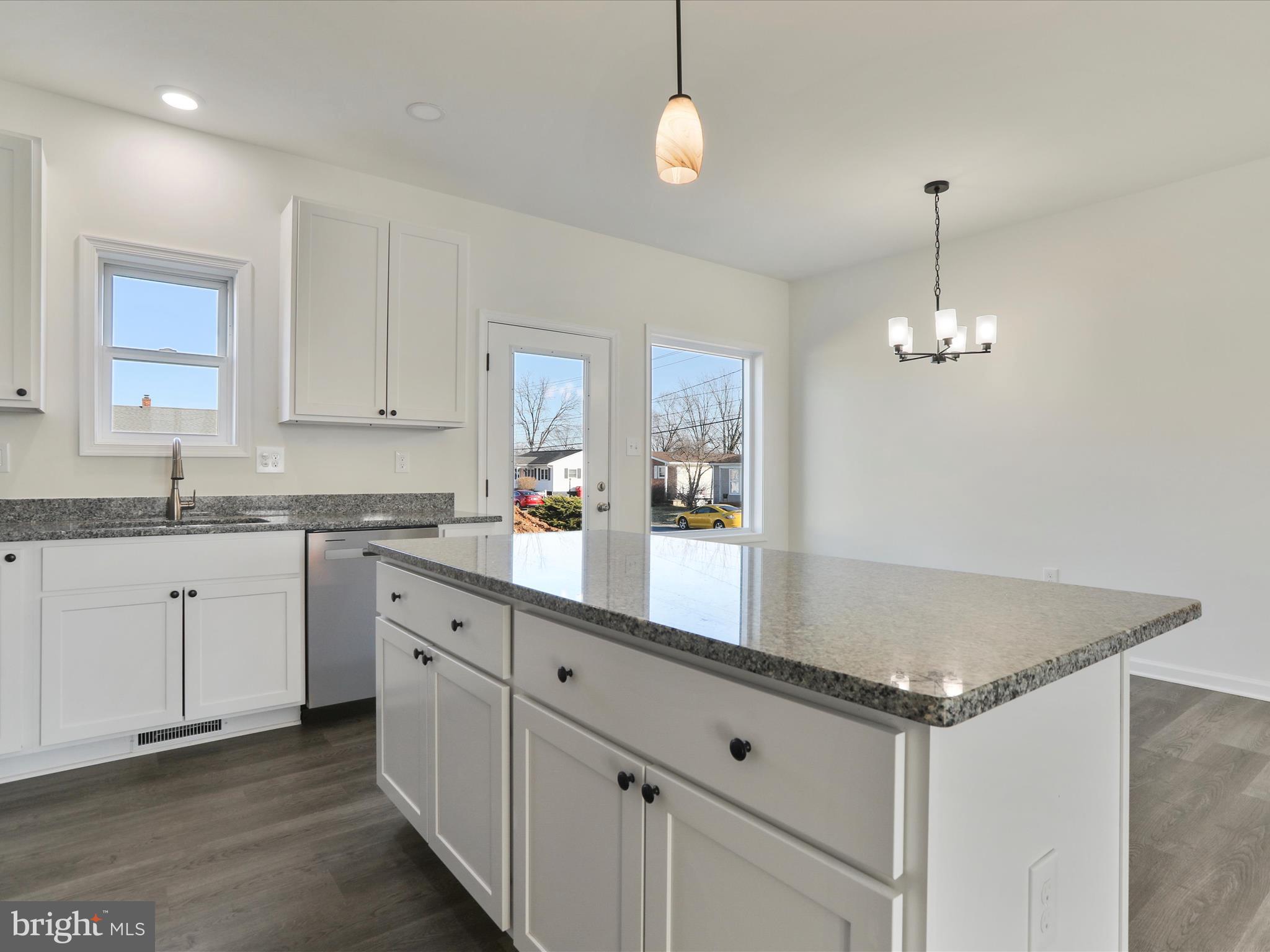 117 East 7th Avenue Ranson, WV 25438 - Photo 8 of 29 a kitchen with granite countertop a sink cabinets and window