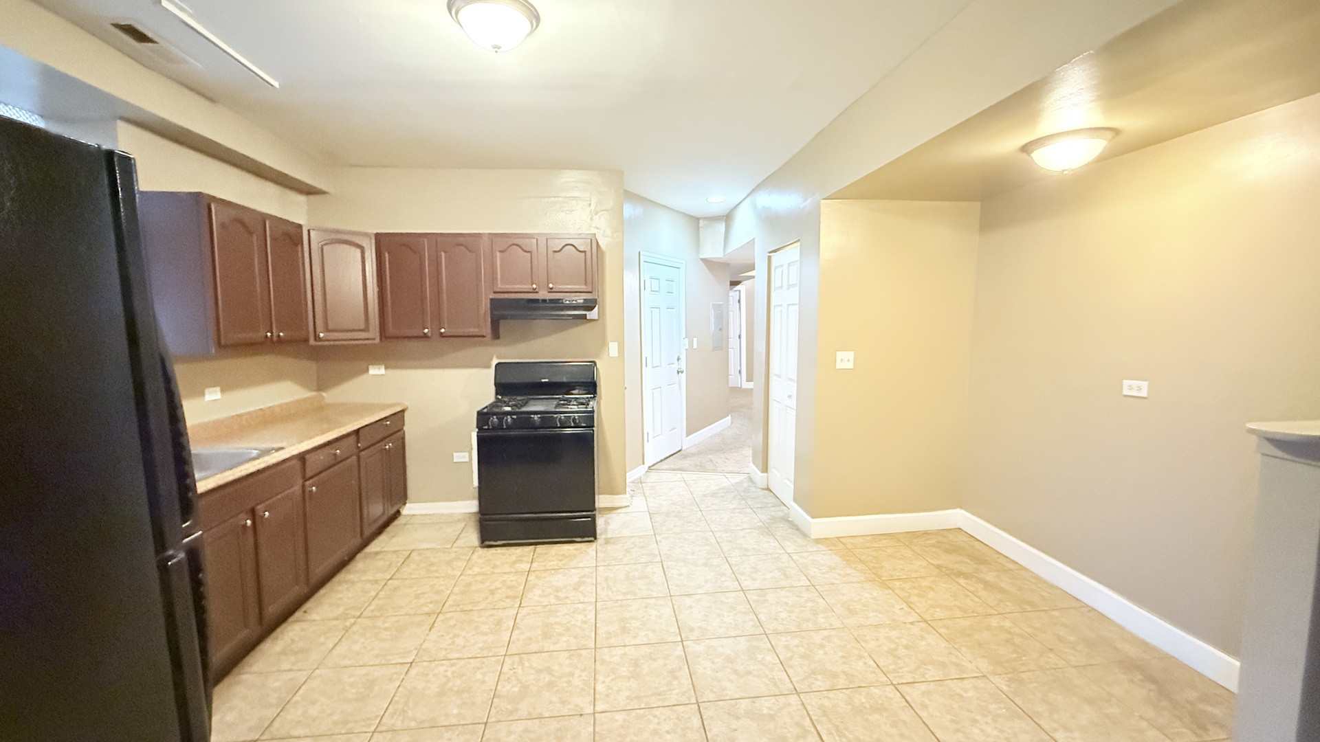 8017 South Phillips Avenue, Unit G Chicago, IL 60617 - Photo 13 of 16 a large kitchen with a stove a refrigerator and a sink