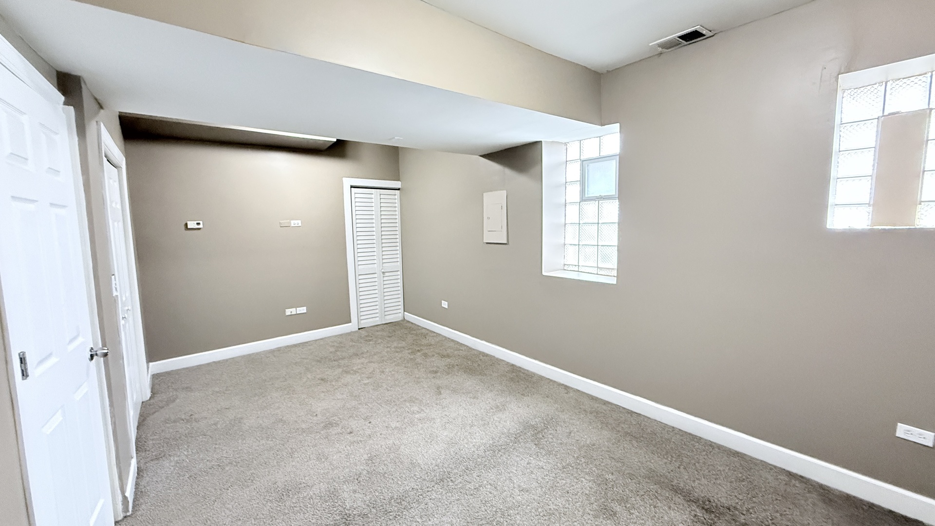 8017 South Phillips Avenue, Unit G Chicago, IL 60617 - Photo 4 of 16 an empty room with windows and closet