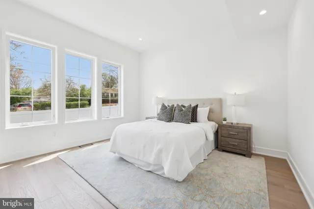 a bathroom with a toilet sink vanity and shower