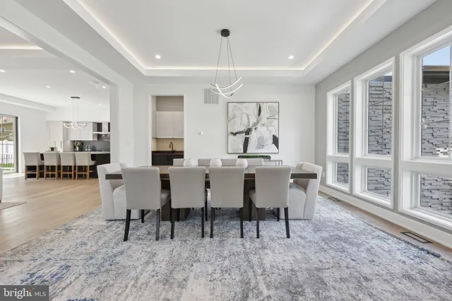 a kitchen with stainless steel appliances wooden floor and a sink