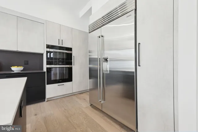 a kitchen with stainless steel appliances granite countertop a stove a microwave and a refrigerator