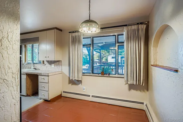 a view of an empty room with a fireplace and a window
