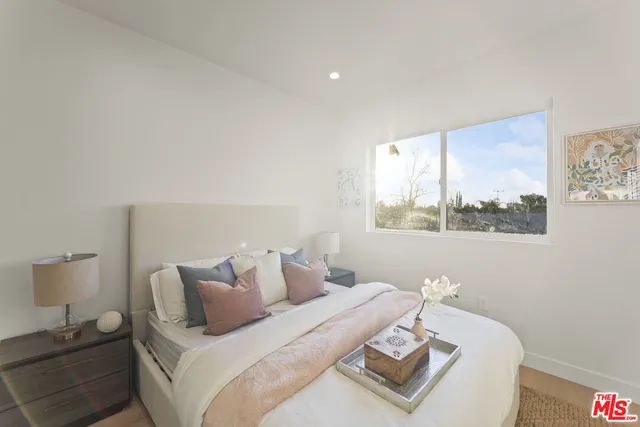 a bedroom with a bed and a window