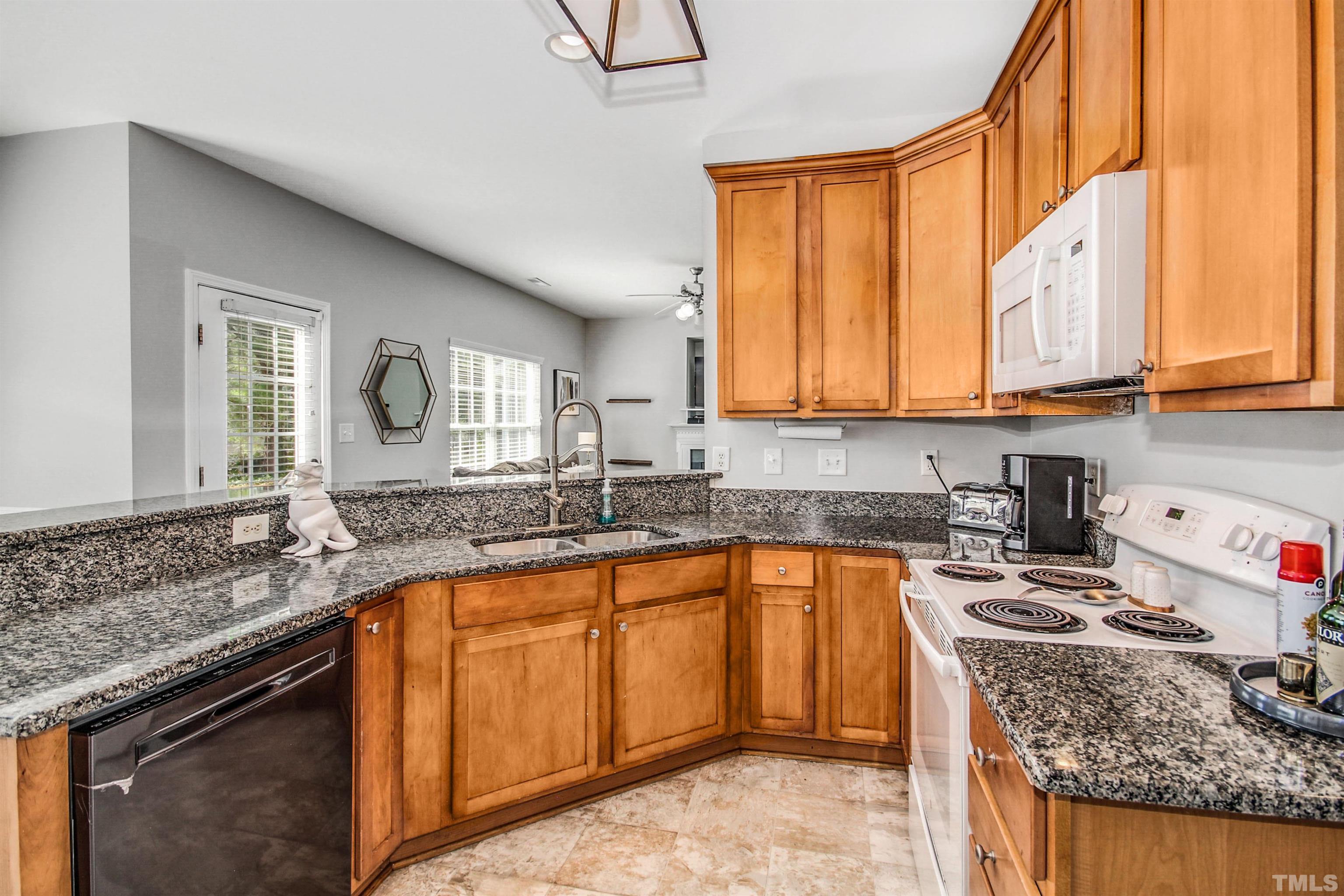 2218 Flowing Drive Raleigh, NC 27610 - Photo 12 of 27 a kitchen with a sink stove and cabinets
