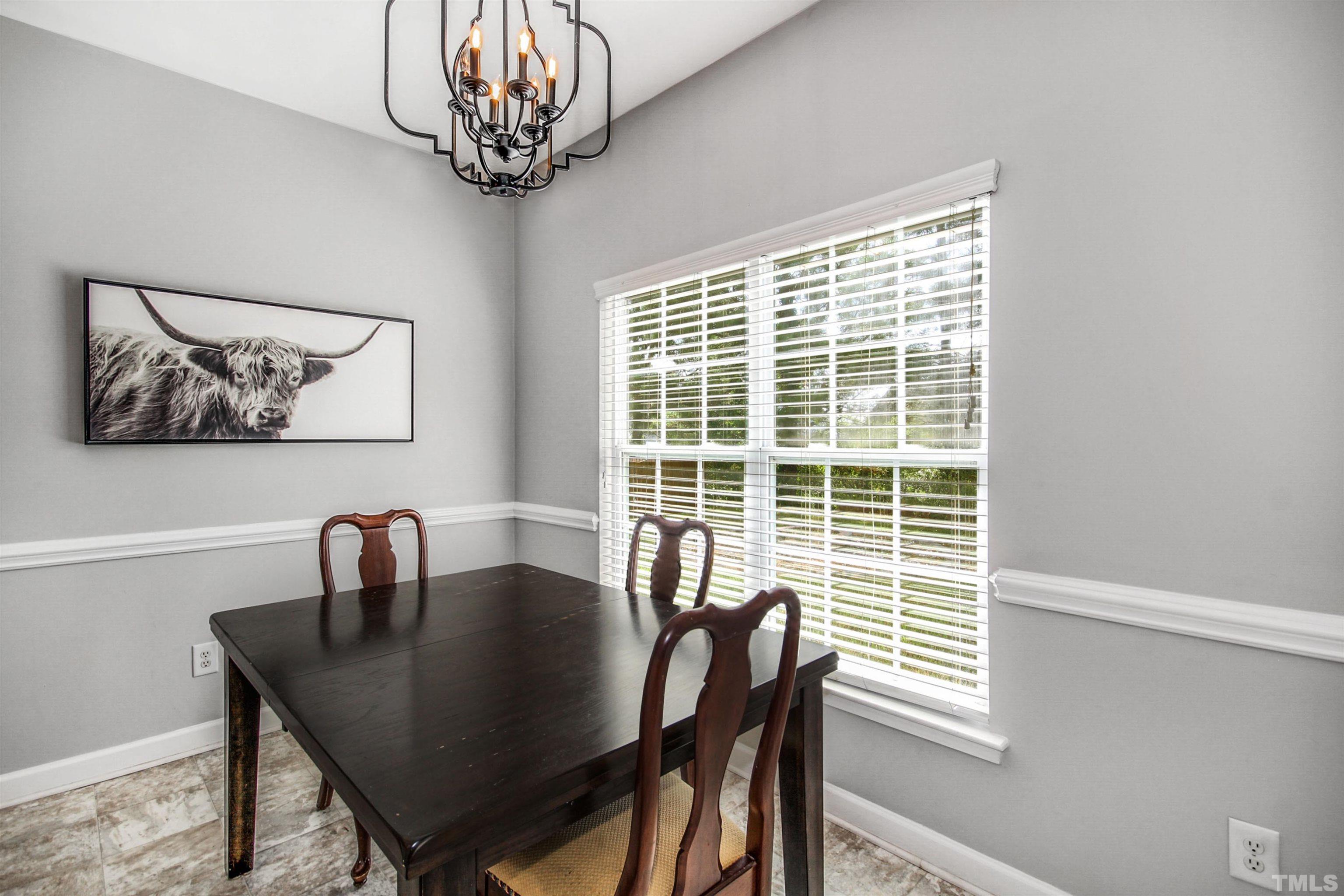2218 Flowing Drive Raleigh, NC 27610 - Photo 13 of 27 a view of a dining room with furniture window and outside view
