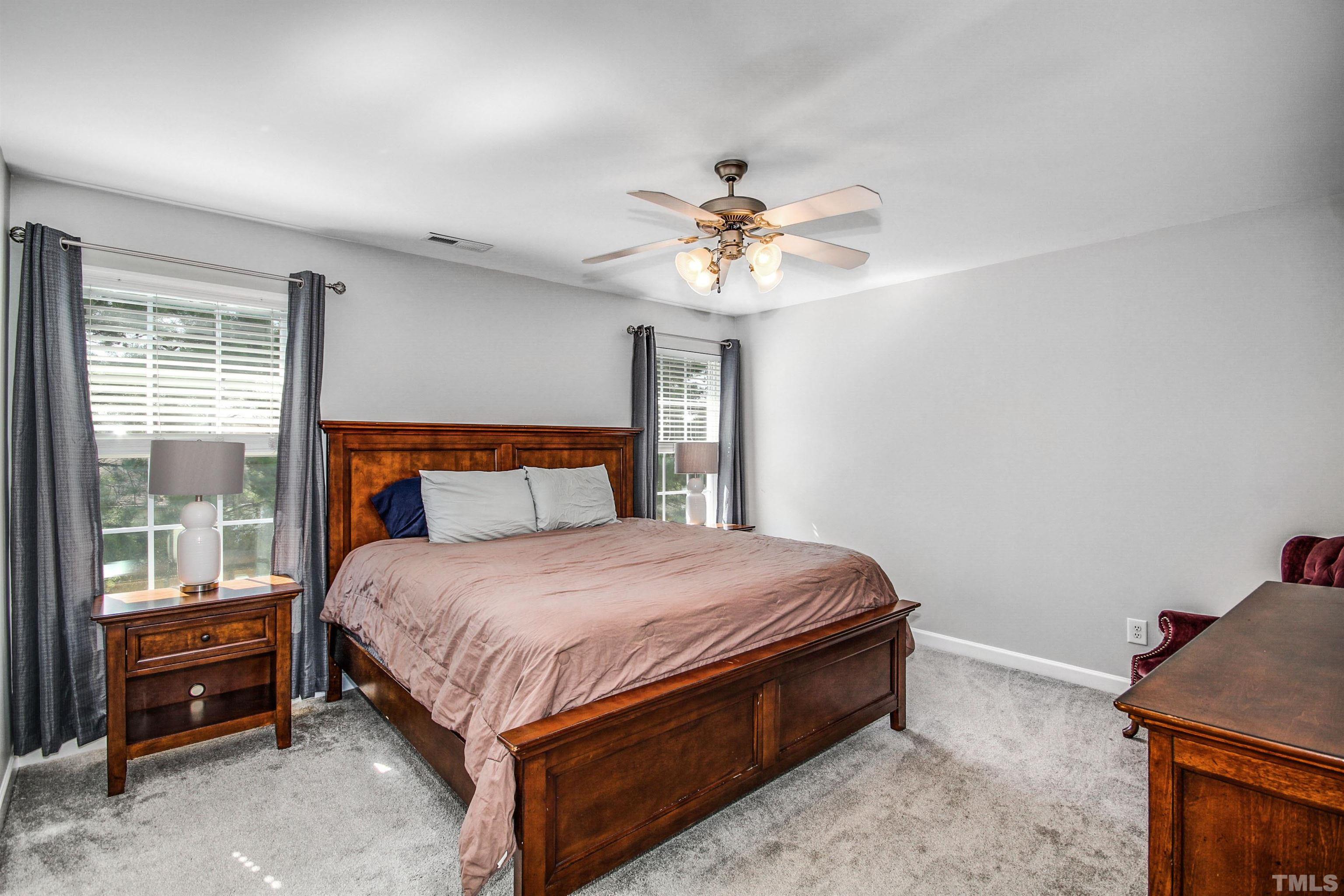 2218 Flowing Drive Raleigh, NC 27610 - Photo 14 of 27 a bed sitting in a bedroom next to a window