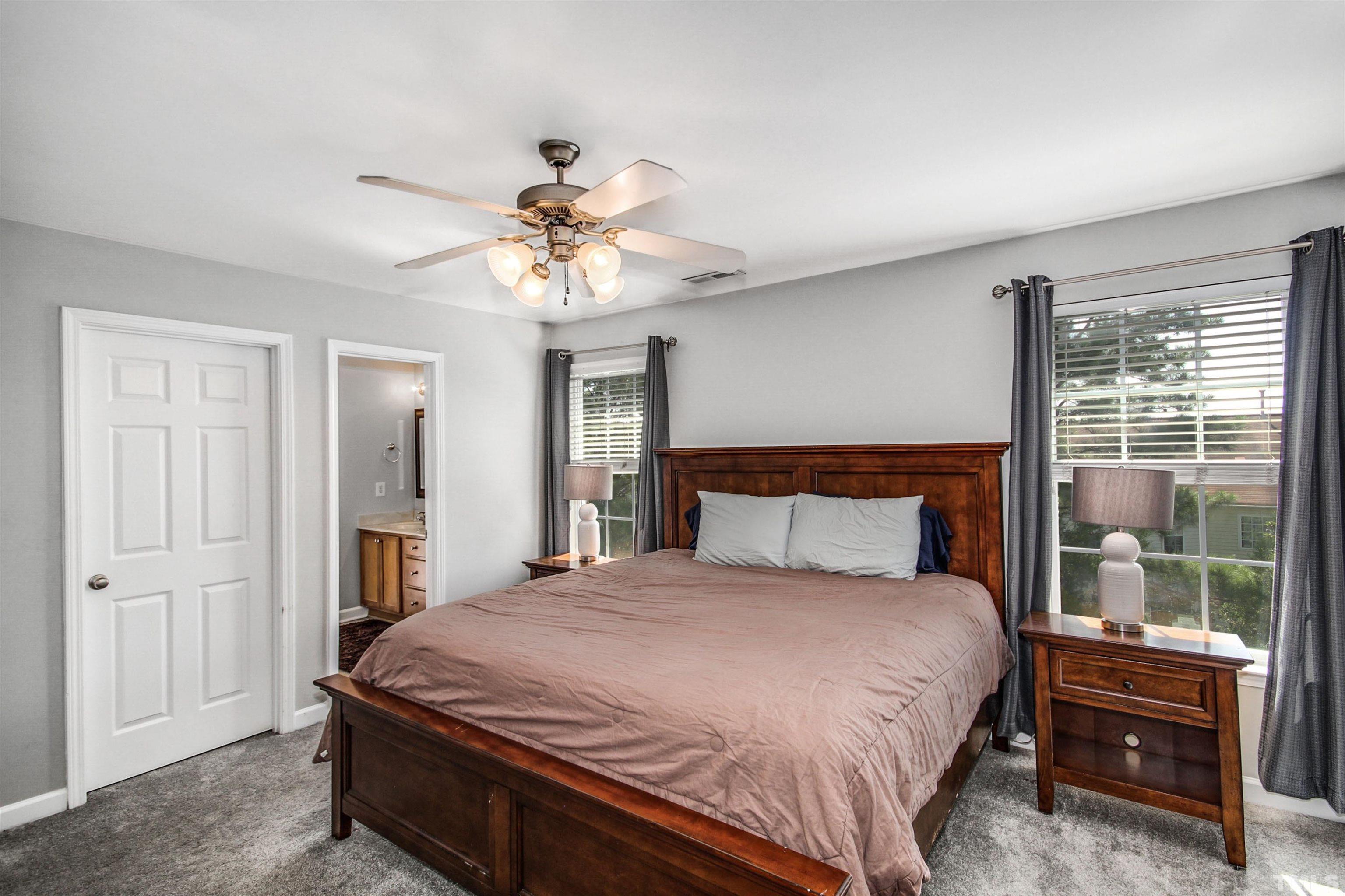 2218 Flowing Drive Raleigh, NC 27610 - Photo 15 of 27 a bedroom with a large bed and a chandelier