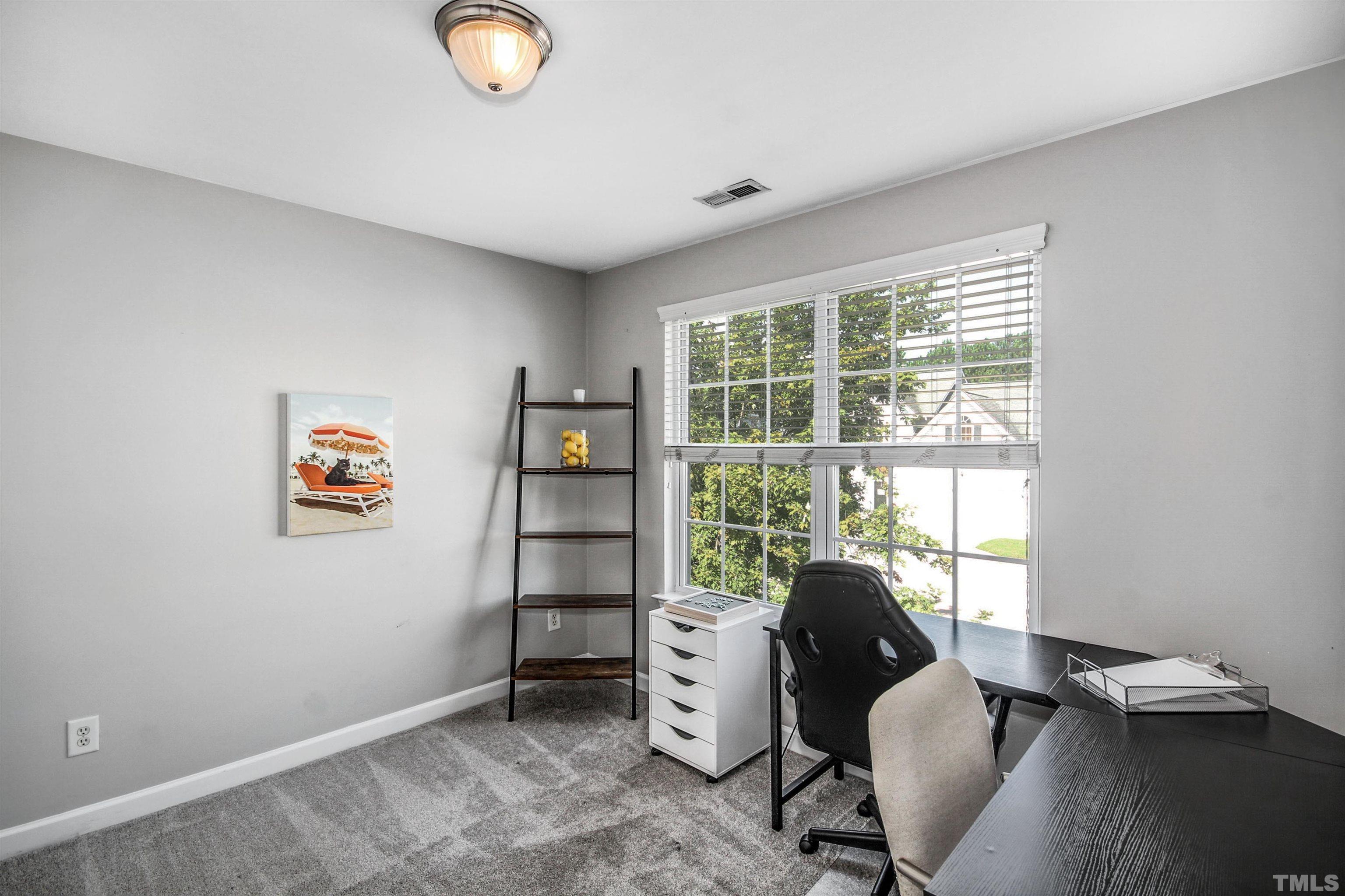 2218 Flowing Drive Raleigh, NC 27610 - Photo 17 of 27 a view of a workspace with furniture and a window