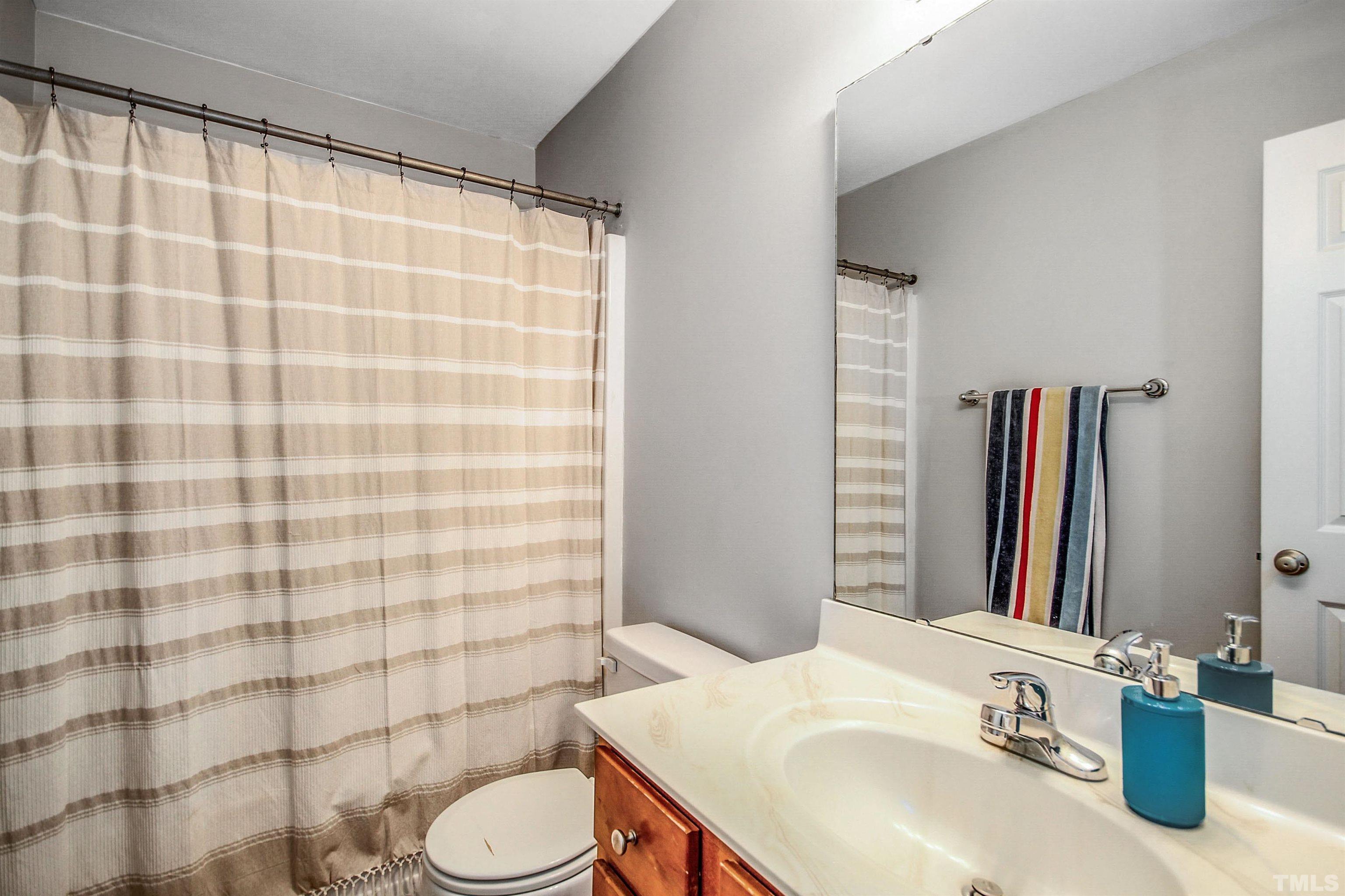 2218 Flowing Drive Raleigh, NC 27610 - Photo 19 of 27 a bathroom with a sink toilet and shower