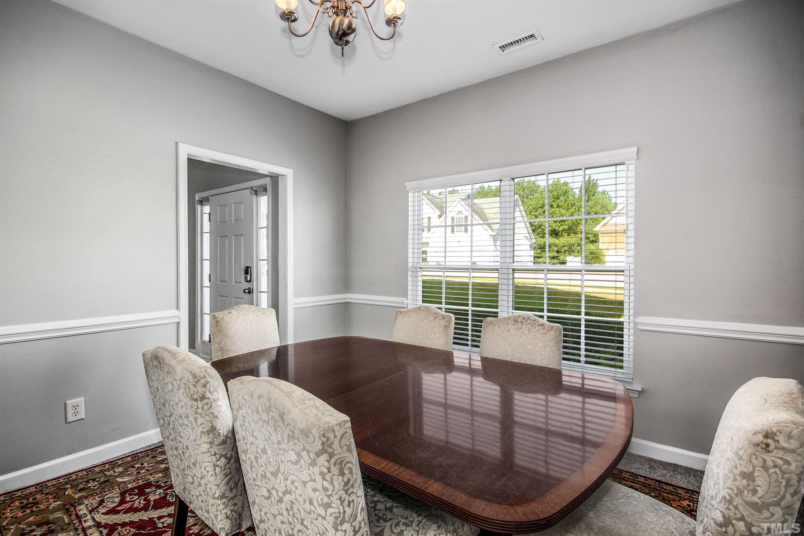 2218 Flowing Drive Raleigh, NC 27610 - Photo 7 of 27 a view of a dining room with furniture and wooden floor