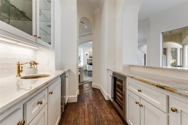 a spacious bathroom with a granite countertop double vanity sink a mirror and a shower