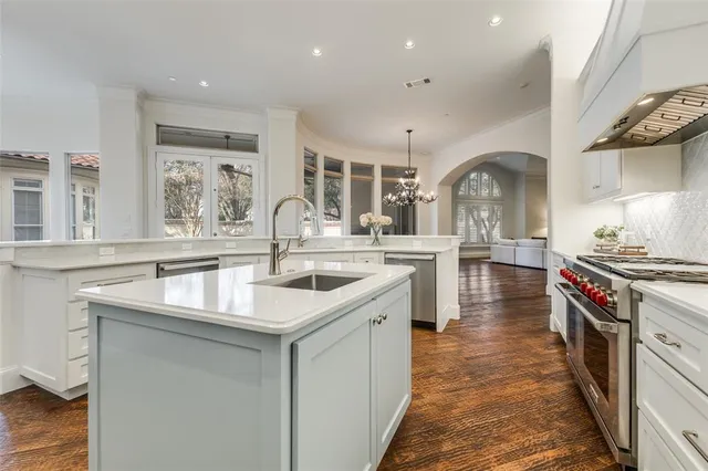 a kitchen with stainless steel appliances granite countertop a sink and a stove