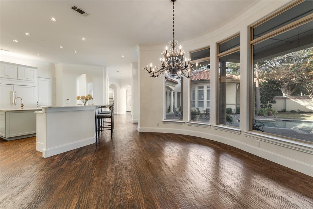 14828 Bellbrook Drive Addison, TX 75254 - Photo 17 of 36 a view of a big room with wooden floor and a kitchen