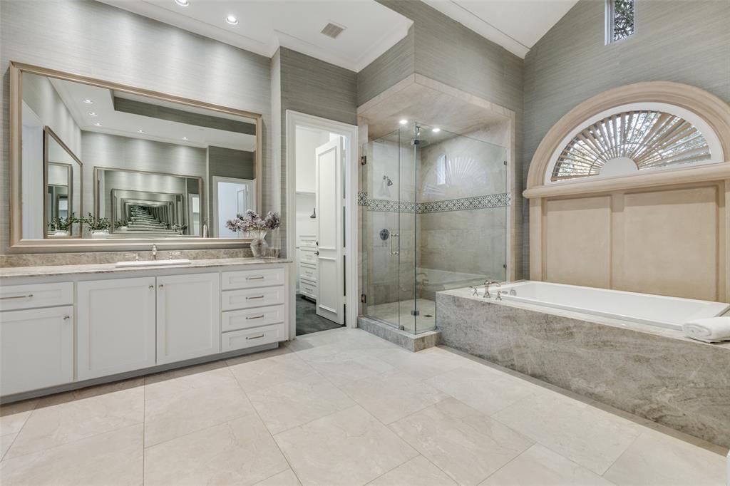 14828 Bellbrook Drive Addison, TX 75254 - Photo 22 of 36 a spacious bathroom with a double vanity sink a large mirror and a bathtub