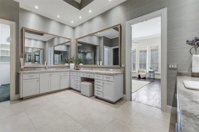 a large white kitchen with a large window