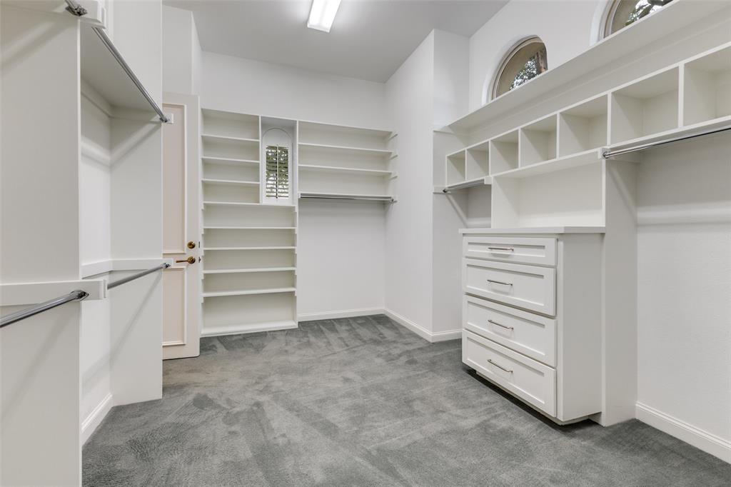 14828 Bellbrook Drive Addison, TX 75254 - Photo 24 of 36 a view of walk in closet with empty racks