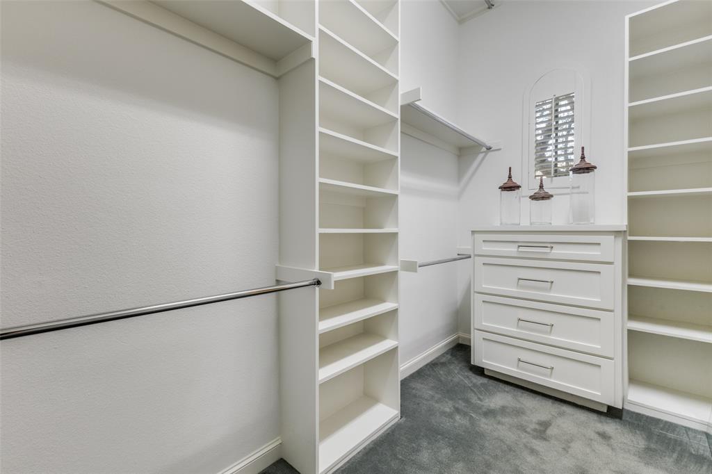 14828 Bellbrook Drive Addison, TX 75254 - Photo 25 of 36 a view of walk in closet with empty racks