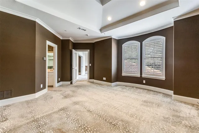 a view of an empty room with a fireplace and a window
