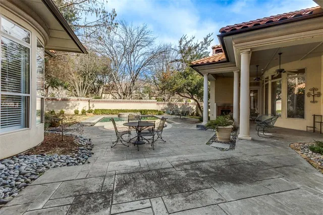 a living room with patio furniture and a fireplace