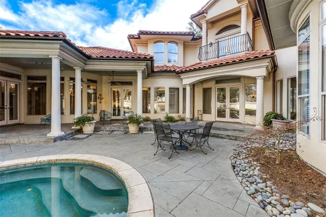 a view of a house with swimming pool and sitting area