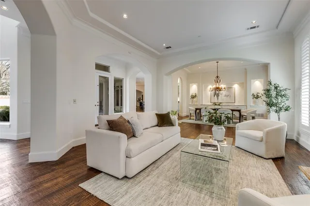 a living room with furniture and view of kitchen