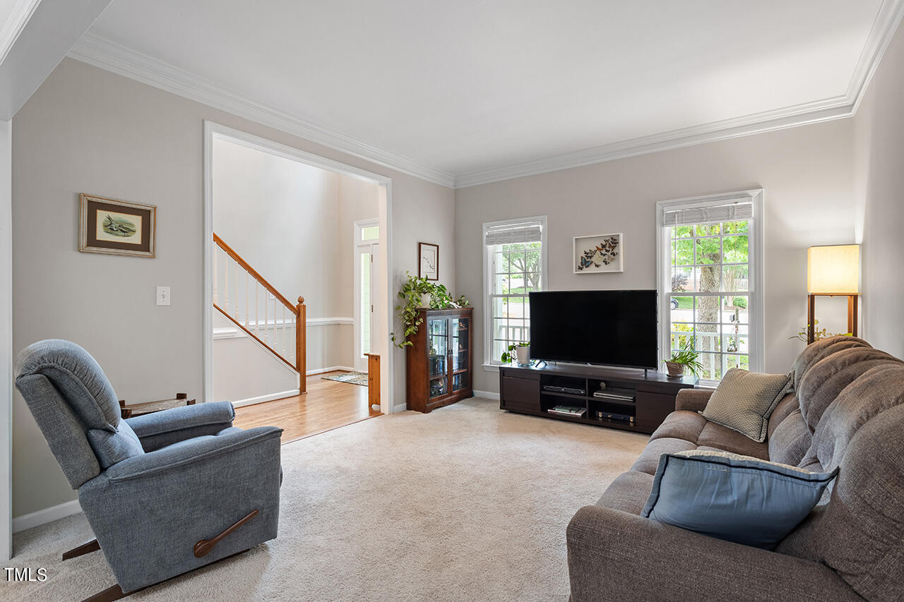 2604 Clerestory Place Raleigh, NC 27615 - Photo 12 of 37 a living room with furniture and a flat screen tv