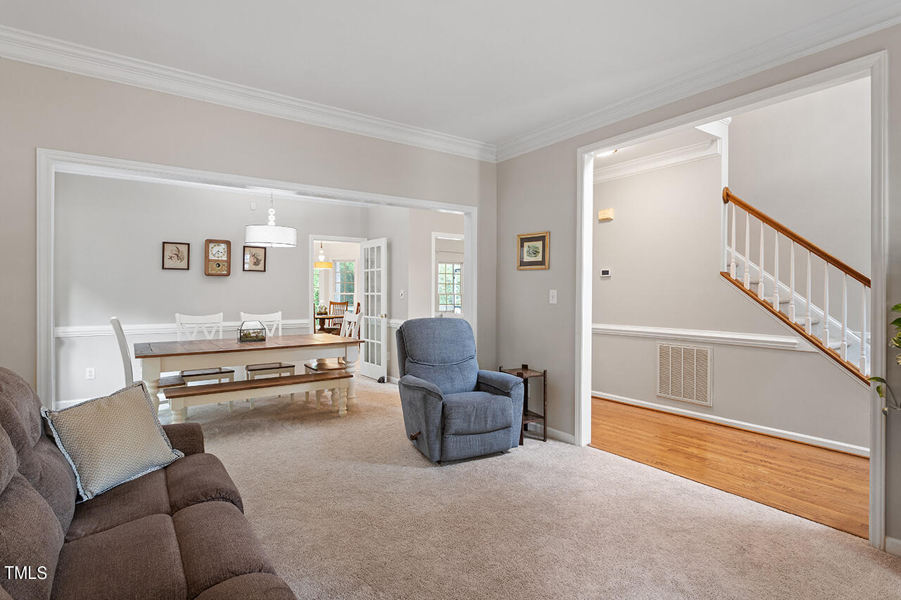 2604 Clerestory Place Raleigh, NC 27615 - Photo 13 of 37 a living room with furniture and a flat screen tv