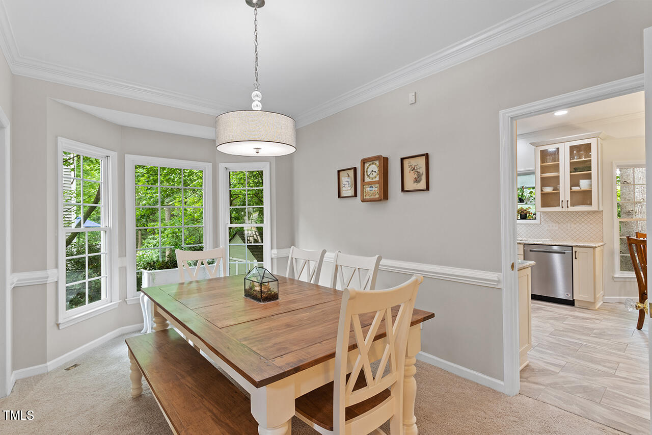 2604 Clerestory Place Raleigh, NC 27615 - Photo 16 of 37 a dining room with a table or chairs and a wooden floor