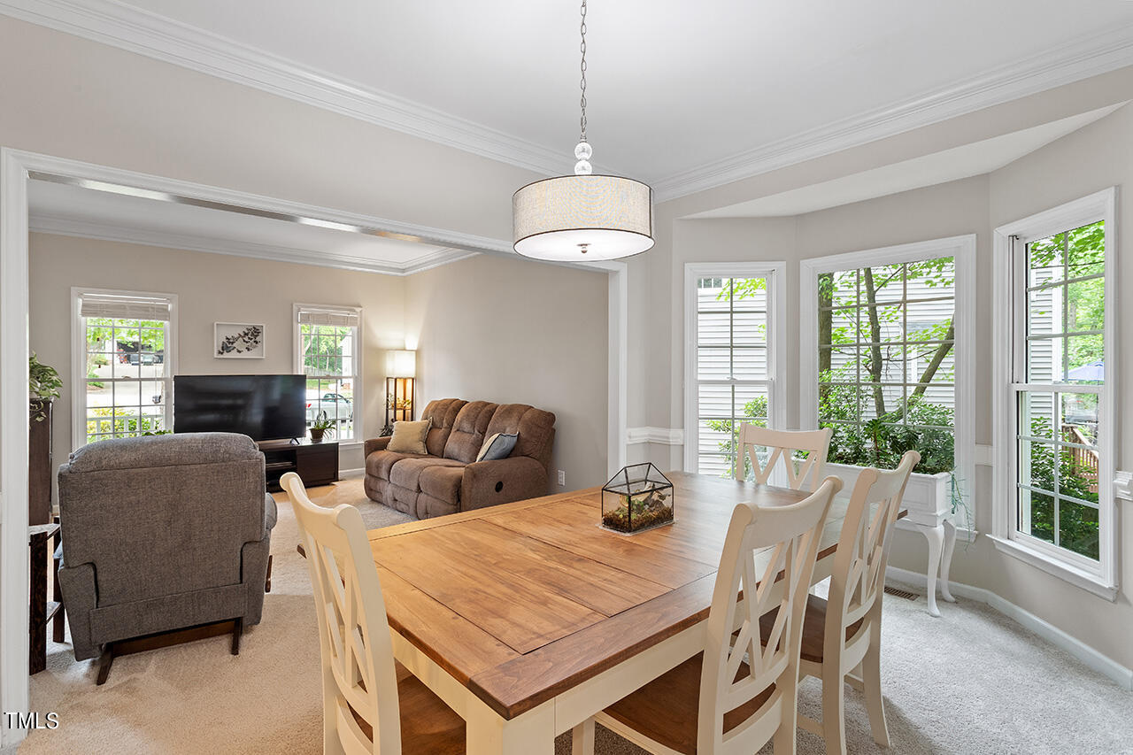 2604 Clerestory Place Raleigh, NC 27615 - Photo 17 of 37 a view of a dining room with furniture window and outside view