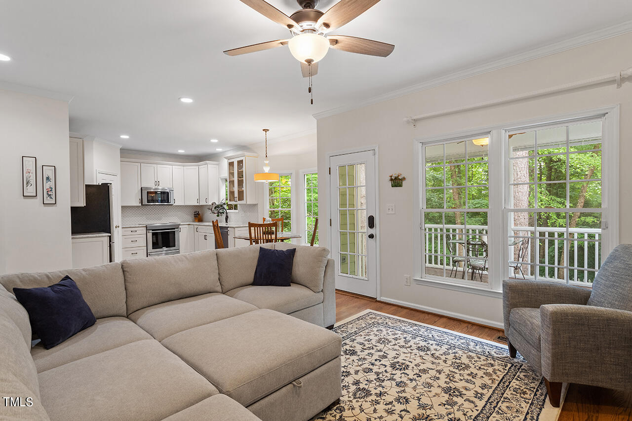 2604 Clerestory Place Raleigh, NC 27615 - Photo 23 of 37 a living room with furniture and a large window with kitchen view