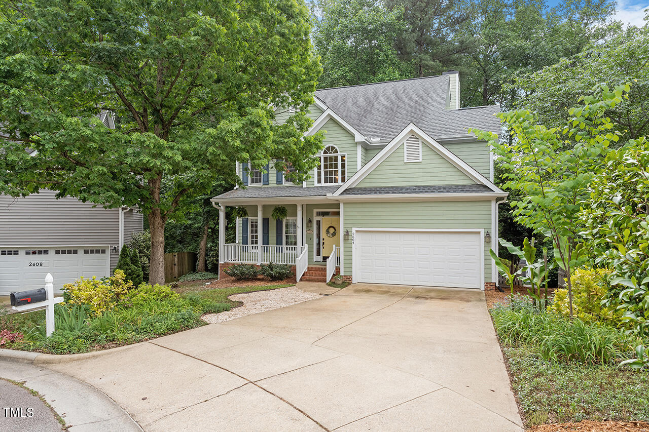 2604 Clerestory Place Raleigh, NC 27615 - Photo 3 of 37 a front view of a house with a garden and trees