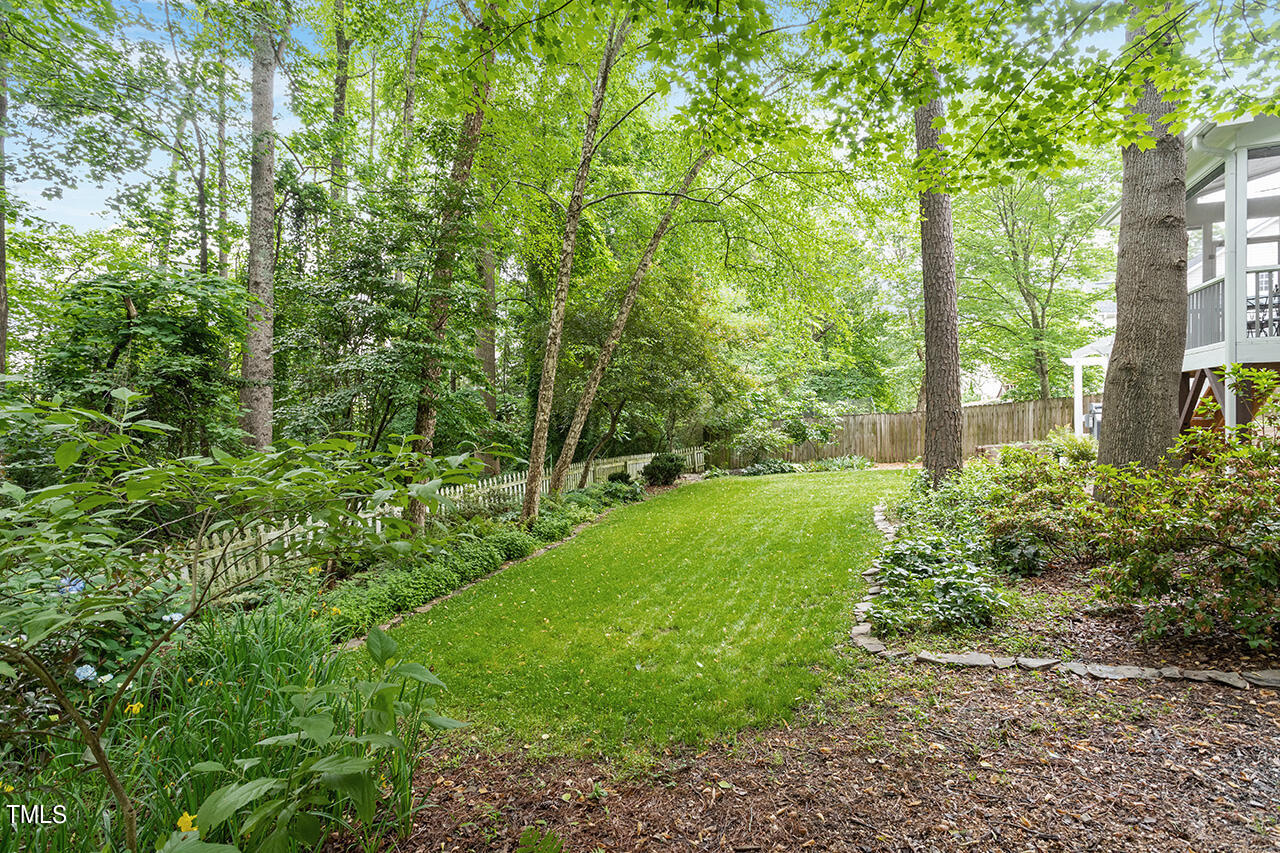 2604 Clerestory Place Raleigh, NC 27615 - Photo 8 of 37 a view of a yard with plants and large trees