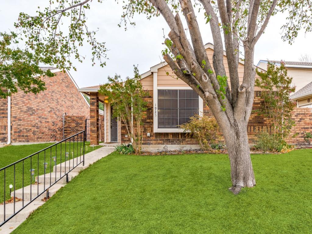 a view of a house with backyard and a tree