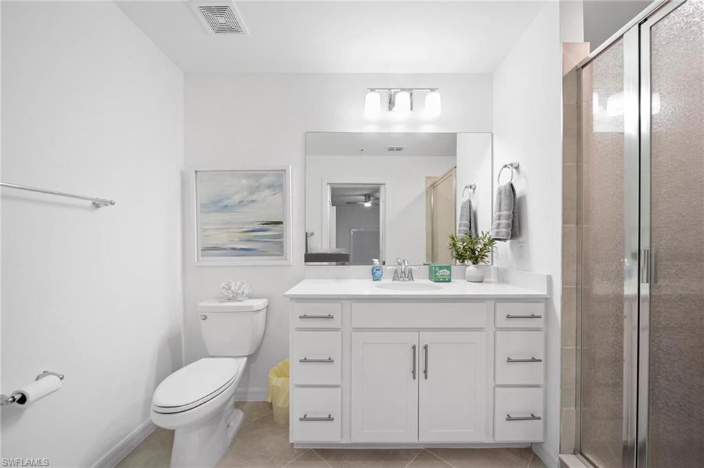 43997 Boardwalk Loop, Unit 1837 Babcock Ranch, FL 33982 - Photo 14 of 26 a bathroom with a sink a toilet a large mirror and shower