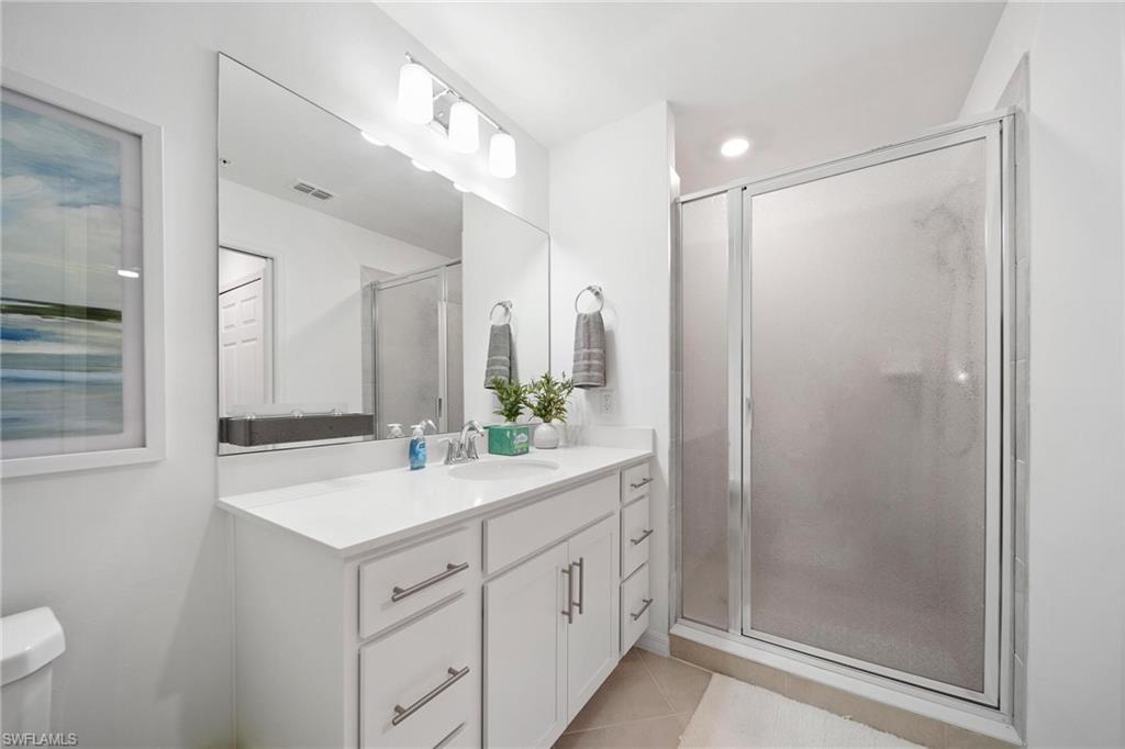 43997 Boardwalk Loop, Unit 1837 Babcock Ranch, FL 33982 - Photo 15 of 26 a bathroom with a double vanity sink mirror and shower