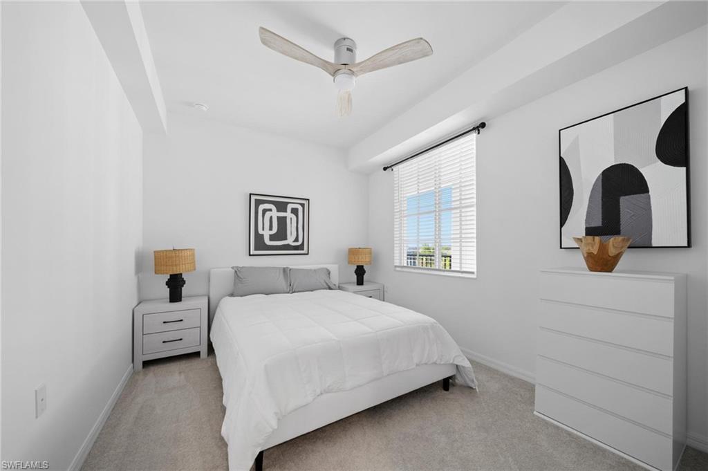 43997 Boardwalk Loop, Unit 1837 Babcock Ranch, FL 33982 - Photo 17 of 26 a bedroom with a large bed and a chandelier