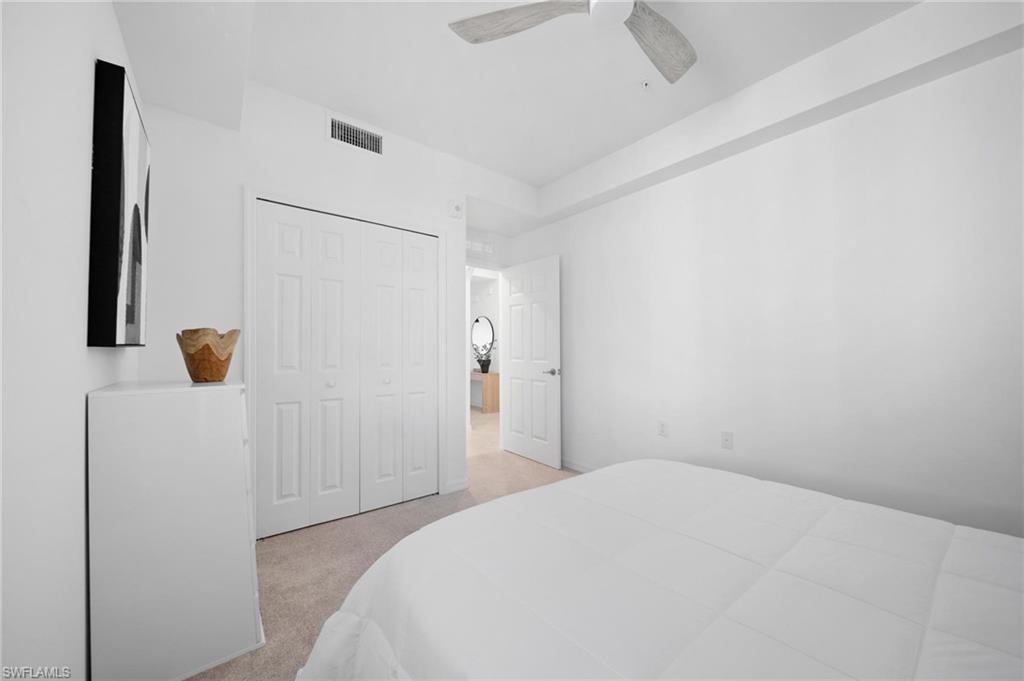 43997 Boardwalk Loop, Unit 1837 Babcock Ranch, FL 33982 - Photo 18 of 26 a bedroom with a bed and a cabinet