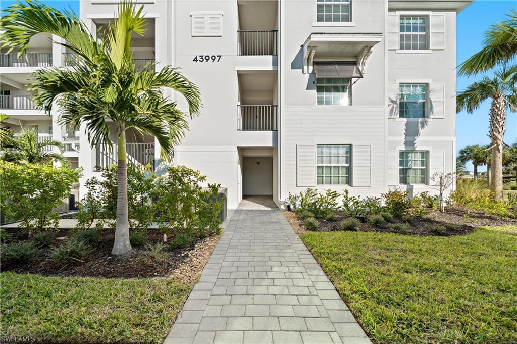 43997 Boardwalk Loop, Unit 1837 Babcock Ranch, FL 33982 - Photo 24 of 26 a view of a pathway with house on both side